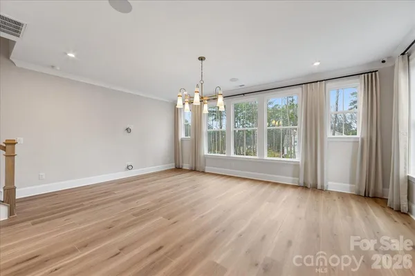 a view of a kitchen with wooden floor and a kitchen