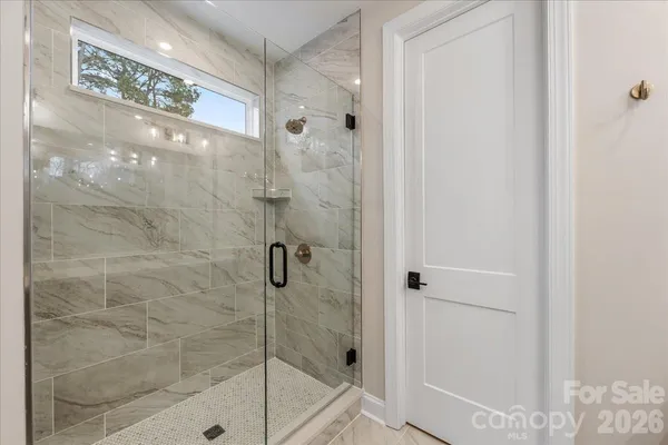 an empty room with a ceiling fan and windows