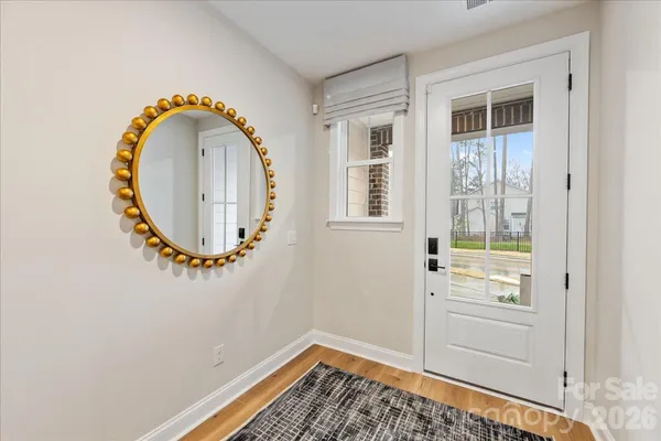 an entryway with wooden floor