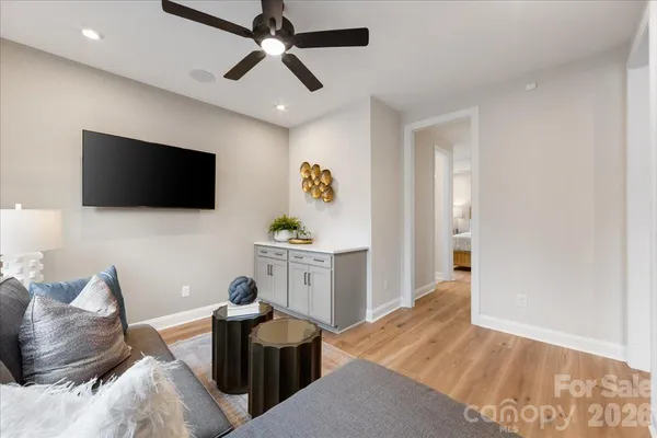 a living room with furniture and wooden floor