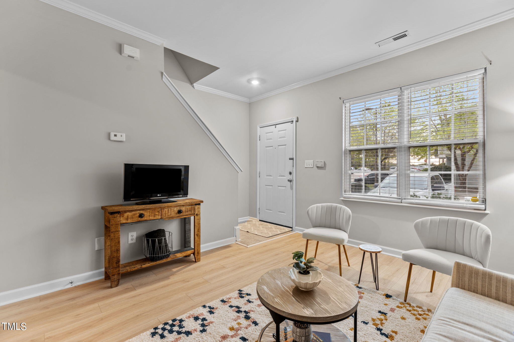 138 Blue Crest Lane Durham, NC 27705 - Photo 5 of 28 a living room with furniture a flat screen tv and a fireplace