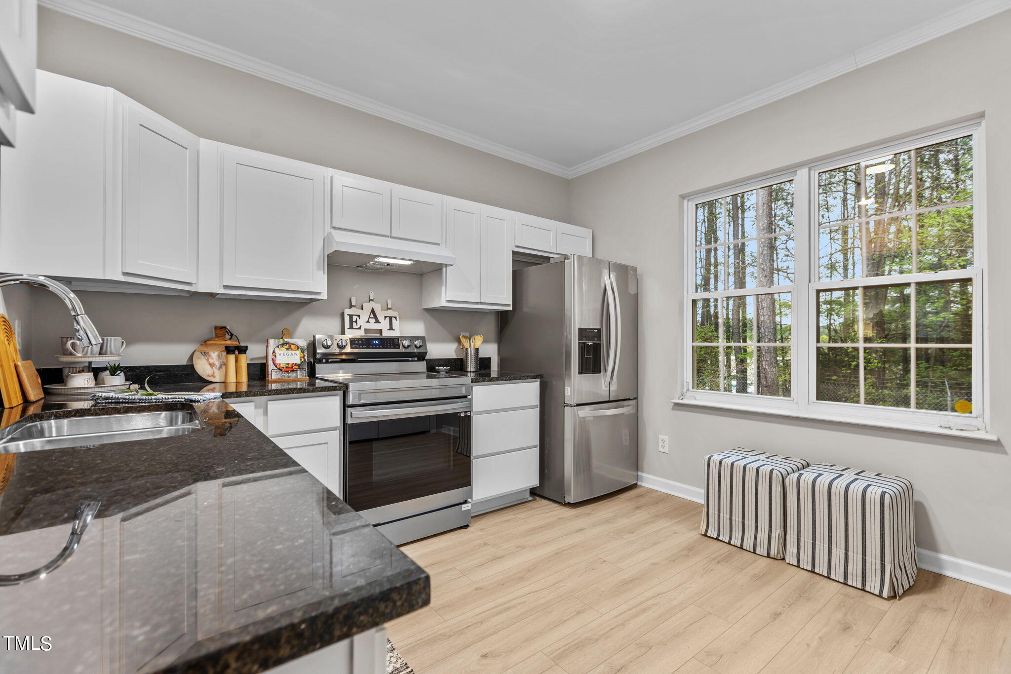 138 Blue Crest Lane Durham, NC 27705 - Photo 7 of 28 a kitchen with granite countertop a stove a sink and a refrigerator