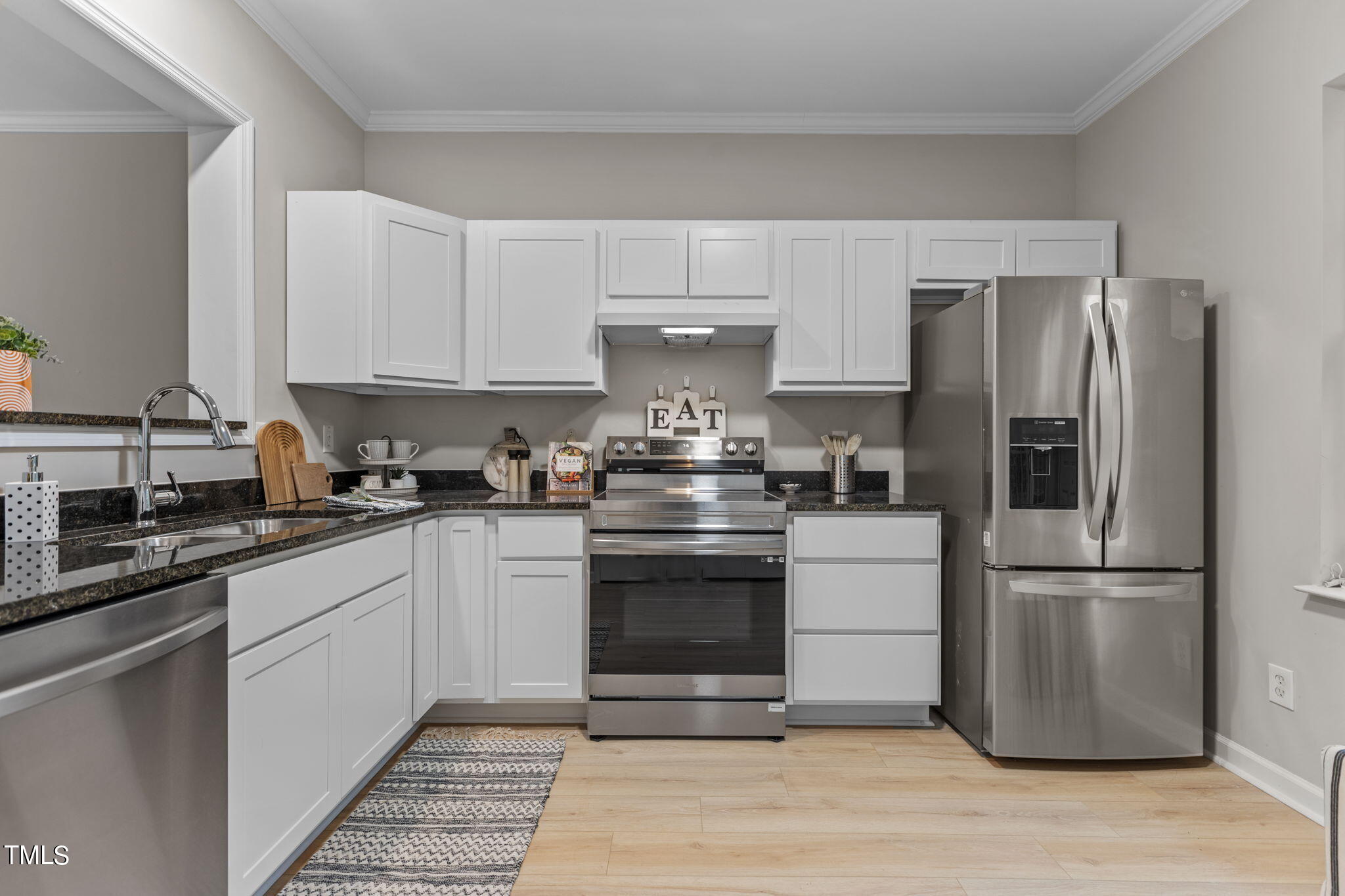 138 Blue Crest Lane Durham, NC 27705 - Photo 8 of 28 a kitchen with a refrigerator stove and white cabinets