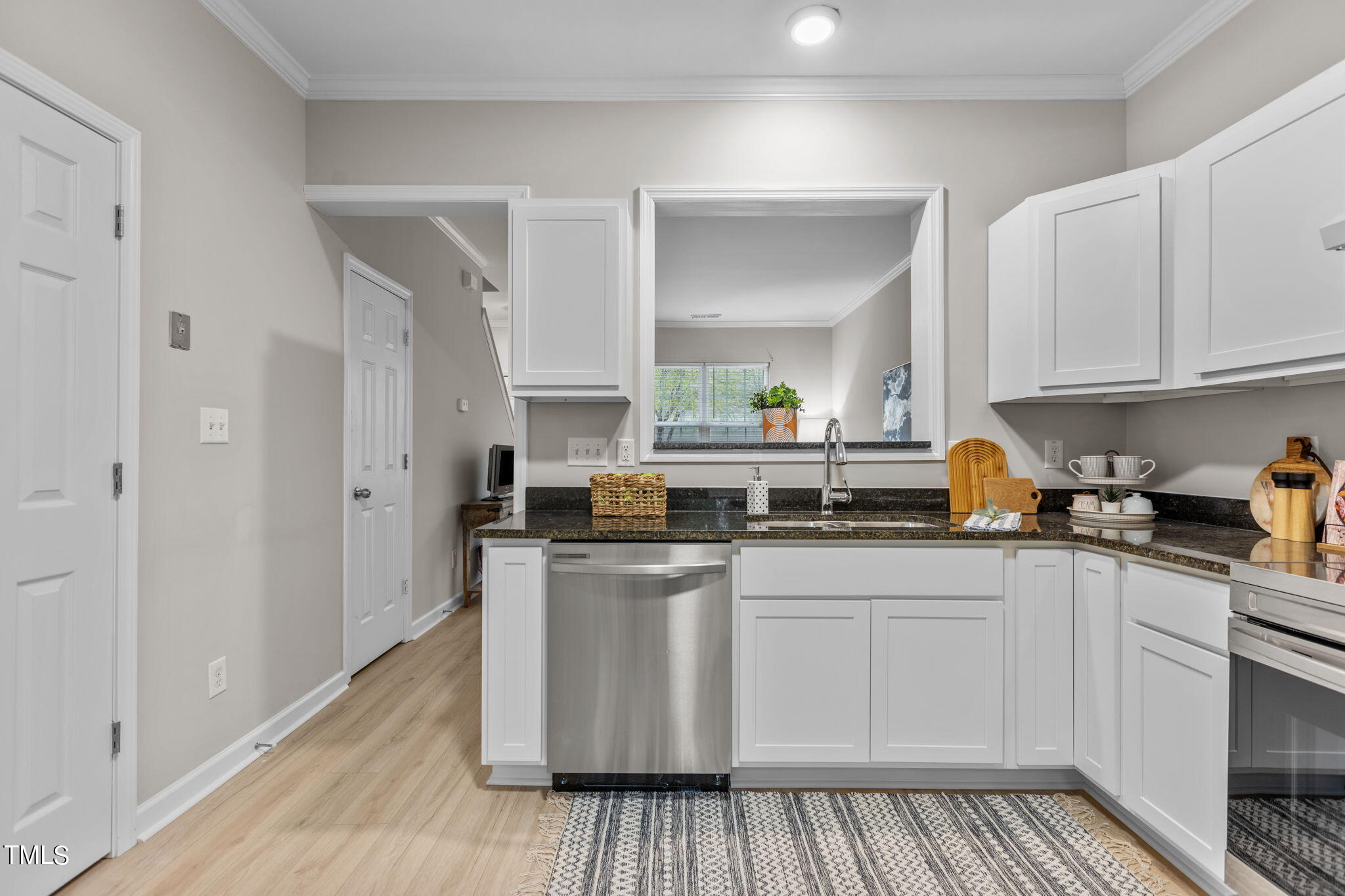 138 Blue Crest Lane Durham, NC 27705 - Photo 9 of 28 a kitchen with stainless steel appliances granite countertop a stove a sink and white cabinets