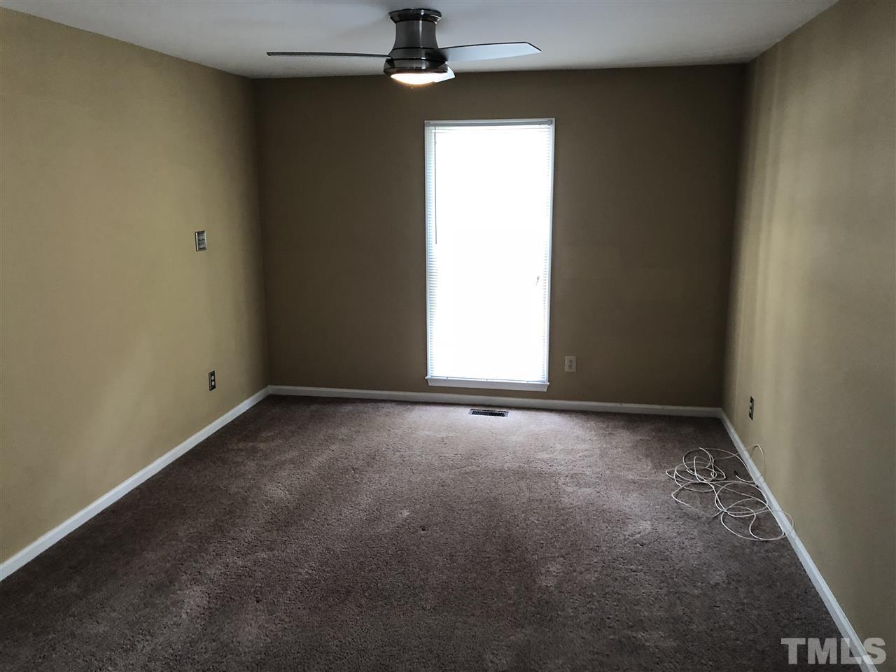 11812 North Exeter Way Raleigh, NC 27613 - Photo 12 of 25 an empty room with a window