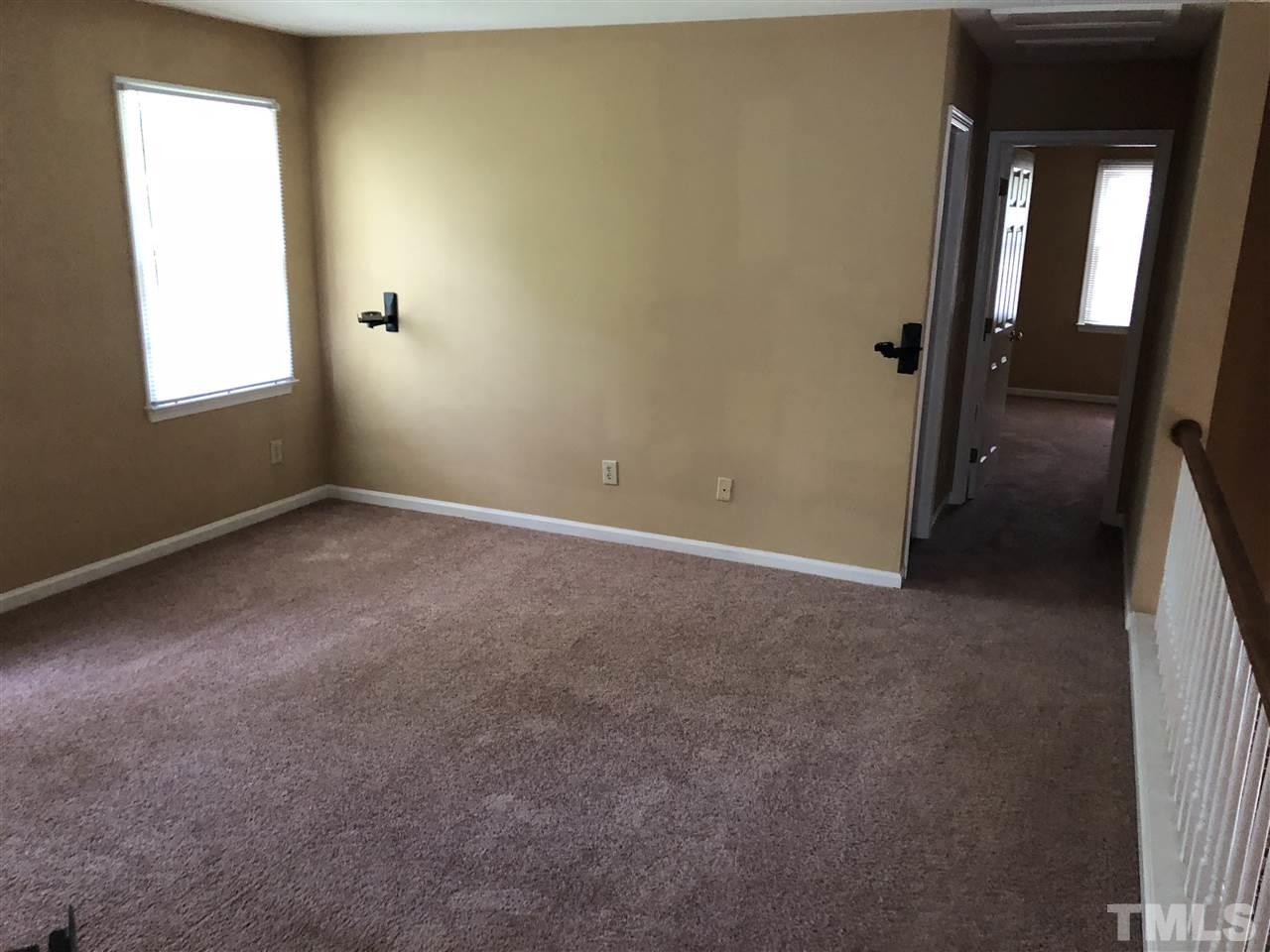 11812 North Exeter Way Raleigh, NC 27613 - Photo 16 of 25 an empty room with windows