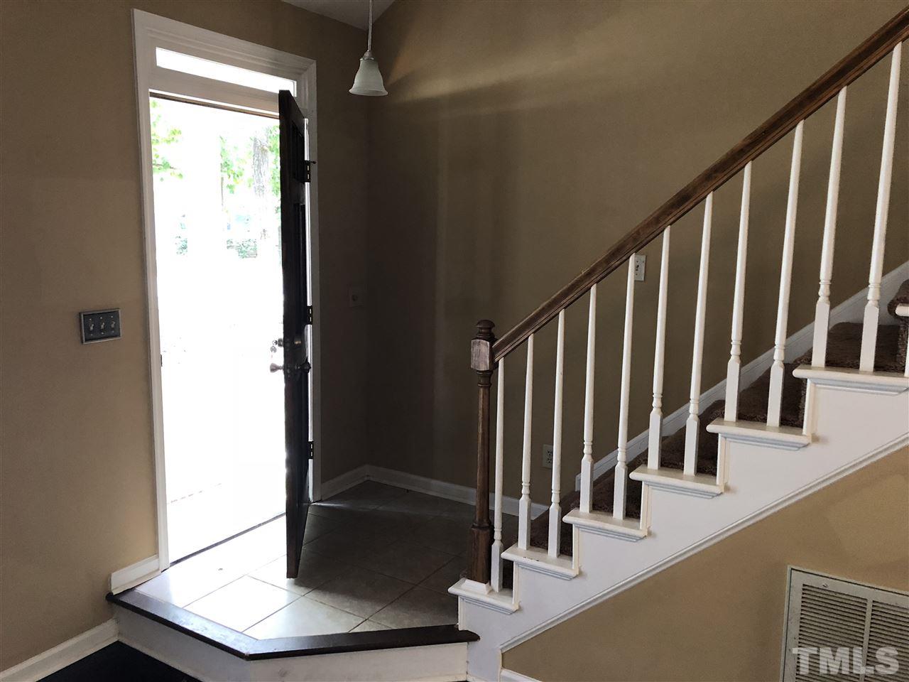 11812 North Exeter Way Raleigh, NC 27613 - Photo 2 of 25 a view of an entryway with wooden floor and staircase