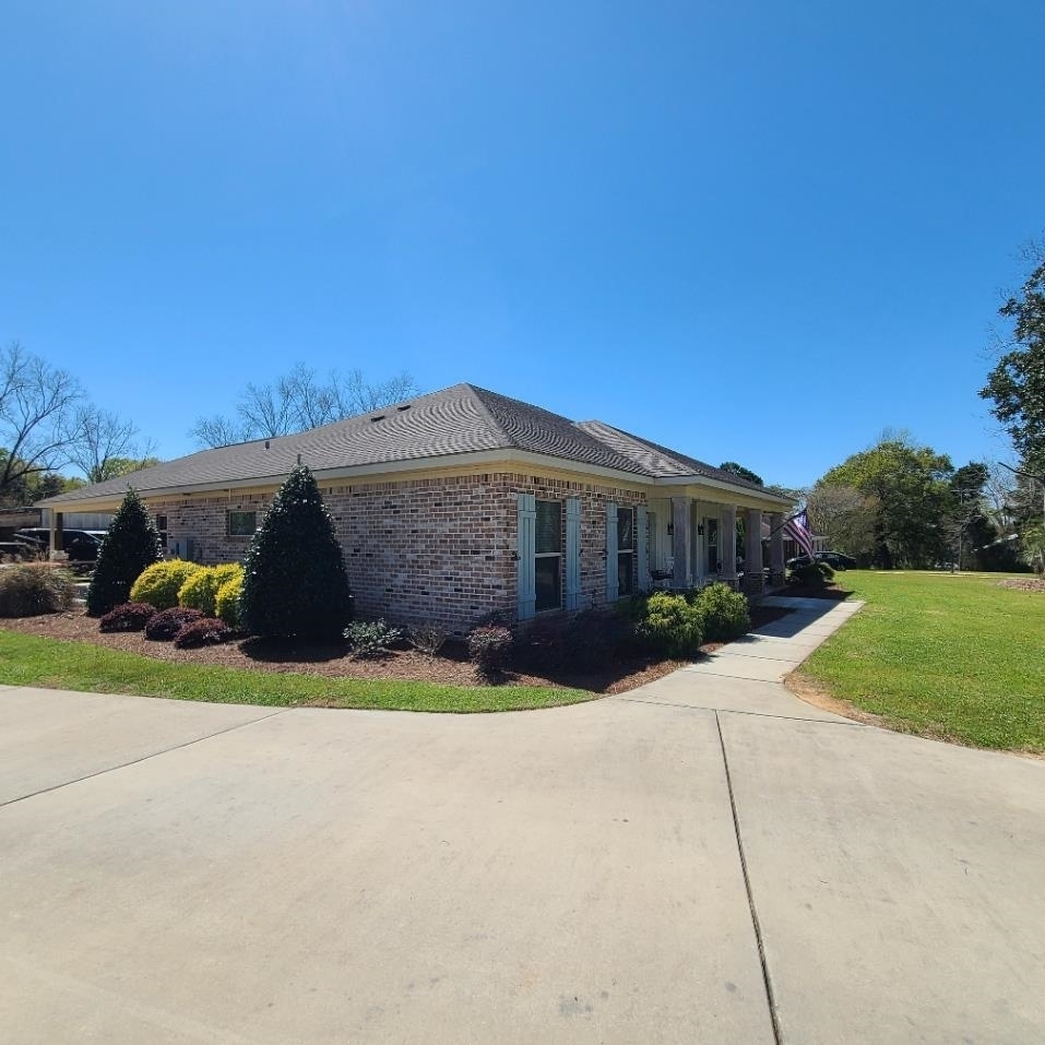 10051 Blackwell Nursery Road Semmes, AL 36575 - Photo 5 of 54 View of property exterior with brick siding, covered porch, and a lawn