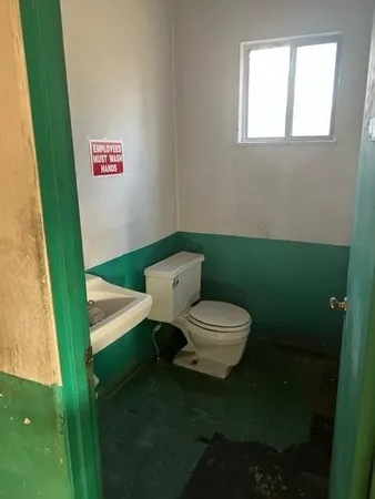 a bathroom with a toilet and a sink