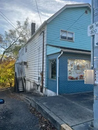 a view of a house with a yard and garage