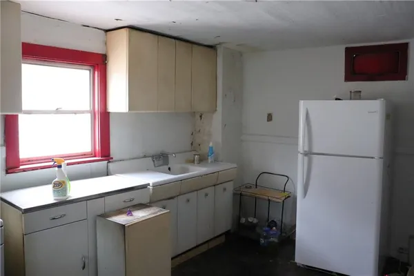 a kitchen with a sink cabinets and window