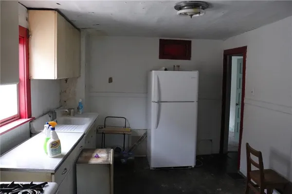 a kitchen with a refrigerator and a sink