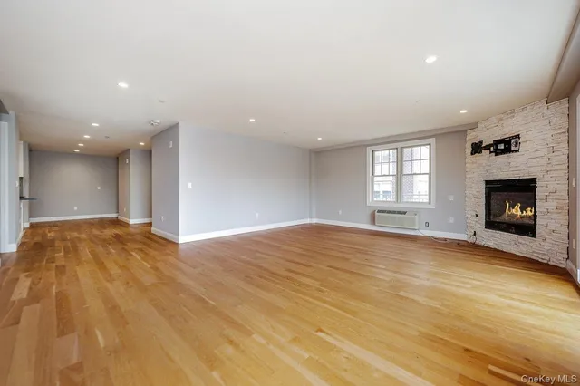 a view of empty room with a fireplace