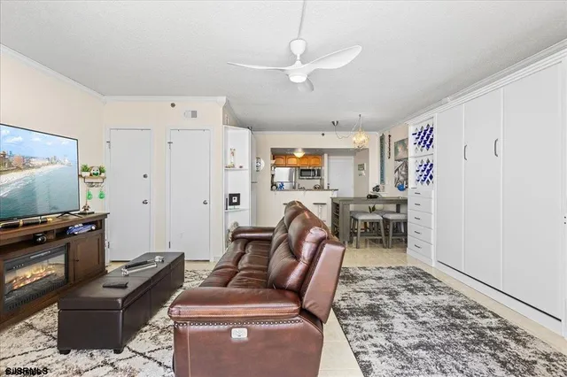 a living room with furniture a flat screen tv and a window