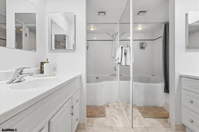 a bathroom with a shower sink and mirror