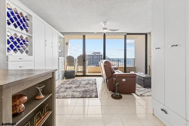 a living room with furniture and large windows
