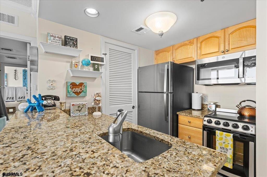 3851 Boardwalk, Unit 2005 Atlantic City, NJ 08401 - Photo 3 of 28 a kitchen with stainless steel appliances granite countertop a sink stove and refrigerator
