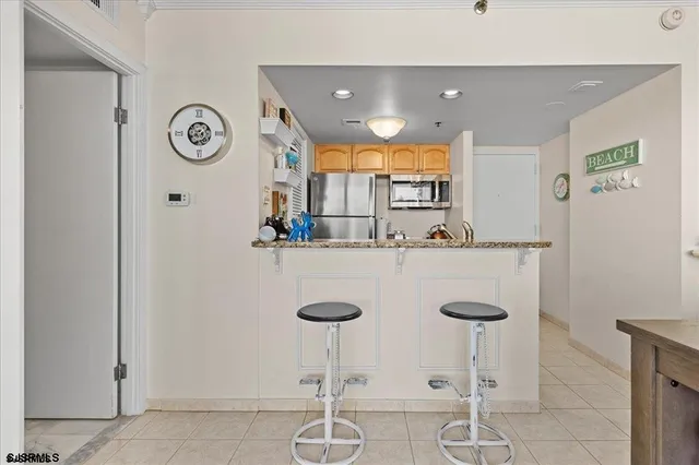 a kitchen with a counter space and chairs in it