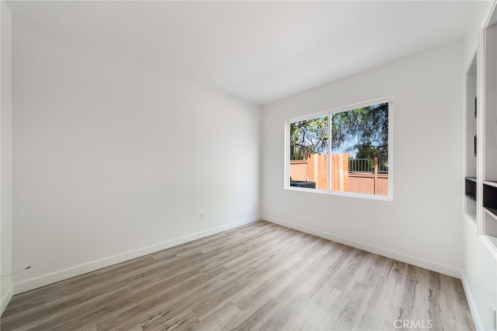 1729 Bridlevale Road Chula Vista, CA 91913 - Photo 15 of 44 an empty room with wooden floor and windows