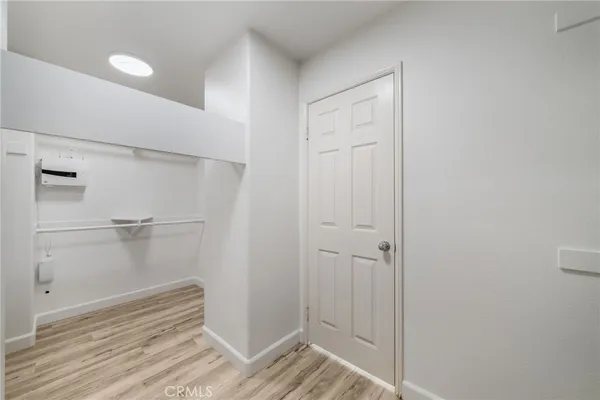 a view of a room with wooden floor