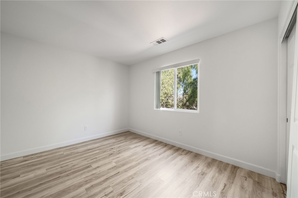 1729 Bridlevale Road Chula Vista, CA 91913 - Photo 25 of 44 an empty room with wooden floor and windows