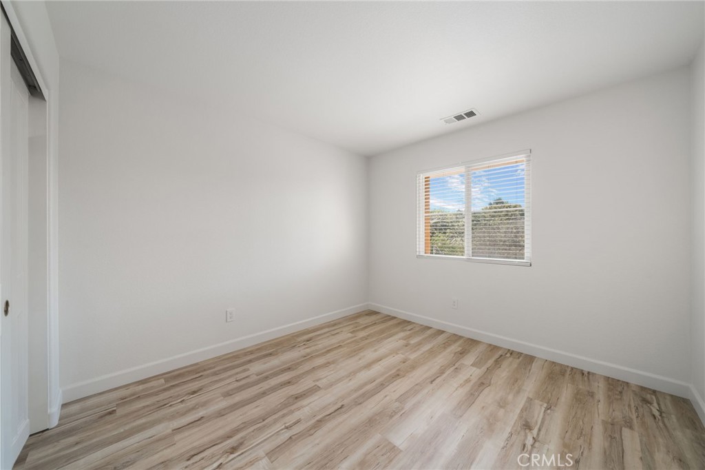 1729 Bridlevale Road Chula Vista, CA 91913 - Photo 29 of 44 an empty room with wooden floor and windows