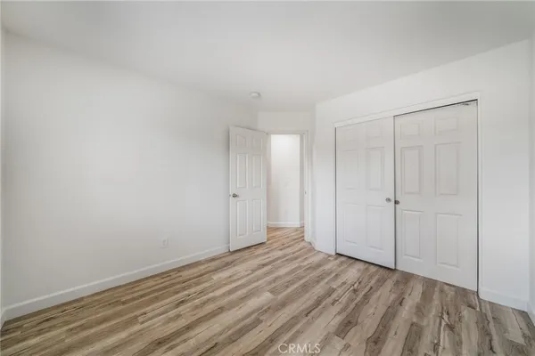 a view of room with wooden floor