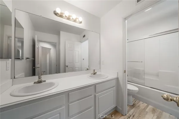 a bathroom with a double vanity sink and a mirror