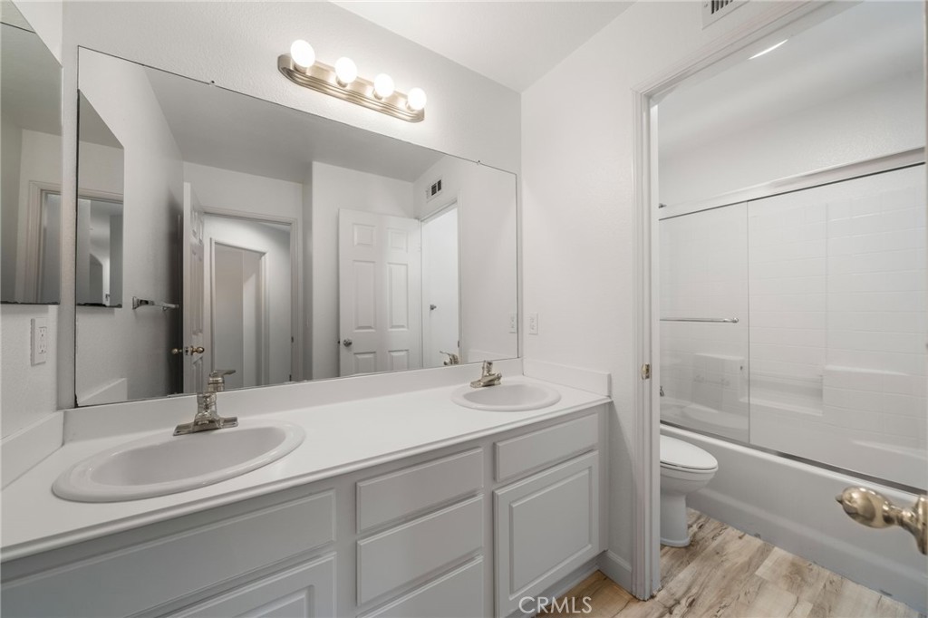 1729 Bridlevale Road Chula Vista, CA 91913 - Photo 31 of 44 a bathroom with a double vanity sink and a mirror