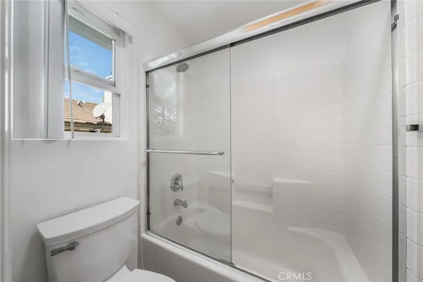 a bathroom with a shower and a toilet