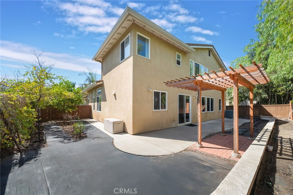1729 Bridlevale Road Chula Vista, CA 91913 - Photo 36 of 44 a view of a white house with a yard and potted plants