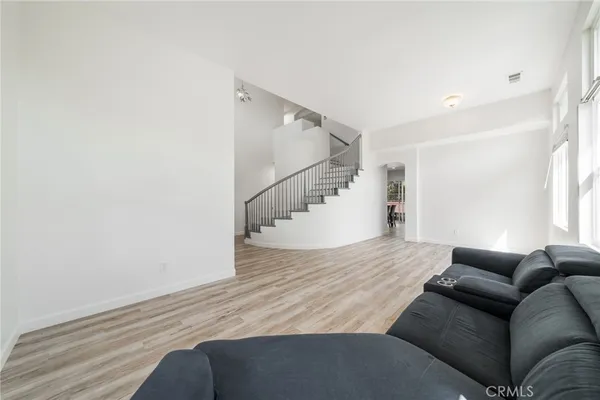 a living room with furniture and stairs