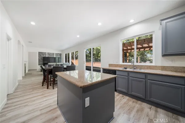 a kitchen with a refrigerator a sink and wooden cabinets