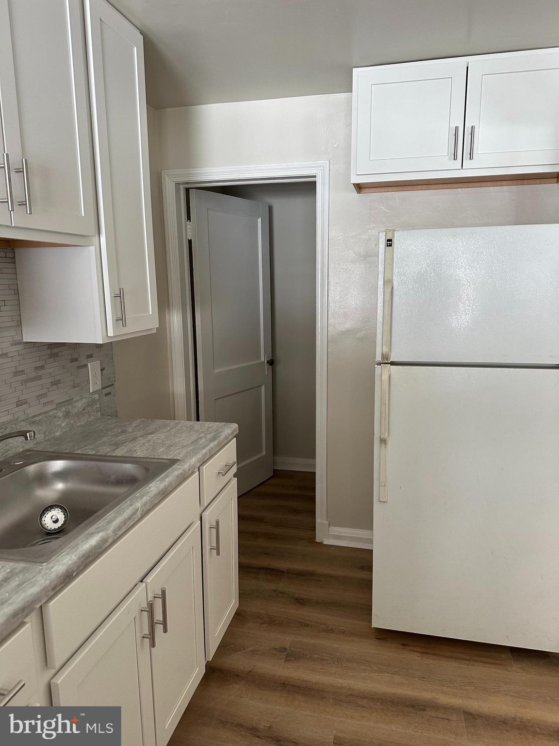 4304 Roberton Avenue Baltimore, MD 21206 - Photo 3 of 11 a kitchen with a refrigerator and a stove
