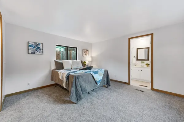 a bed room with a bed and a window