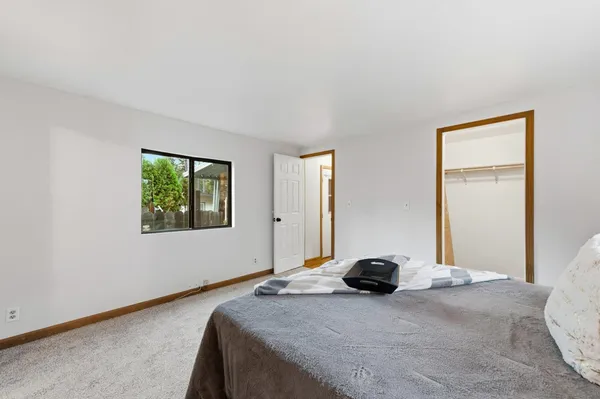 a bedroom with a bed and a window