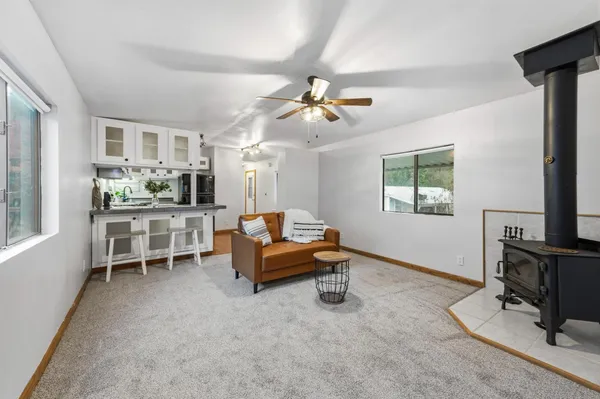 a living room with furniture a flat screen tv and a window