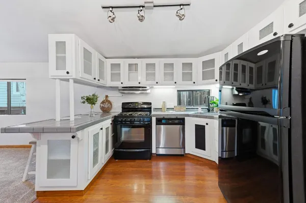 a kitchen with stainless steel appliances granite countertop a stove and a sink