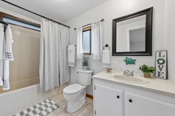 a bathroom with a toilet a sink and a mirror