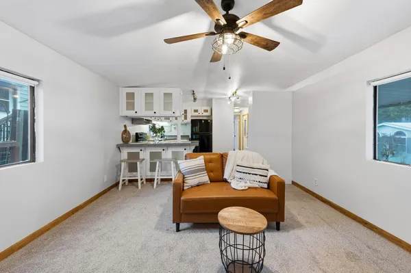a living room with furniture and a chandelier