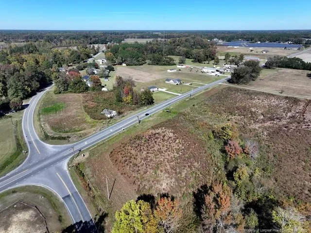 an aerial view of a house with a yard and lake view