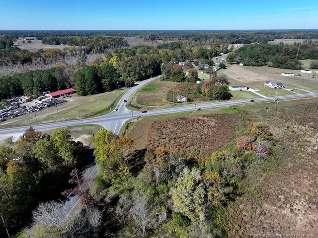 an aerial view of a houses with a yard