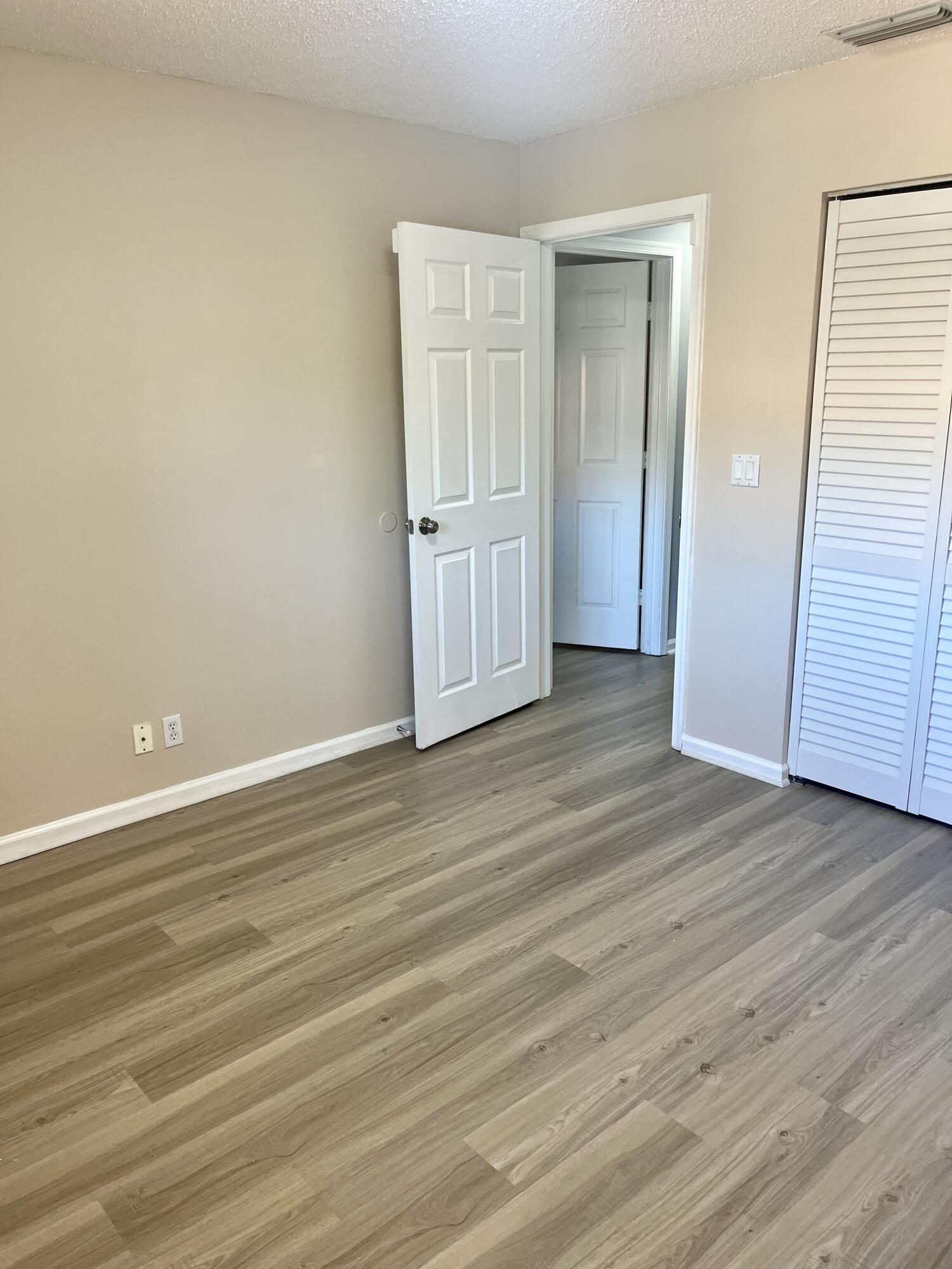 17262 Boca Club Boulevard, Unit 2407 Boca Raton, FL 33487 - Photo 23 of 25 an empty room with wooden floor and closet