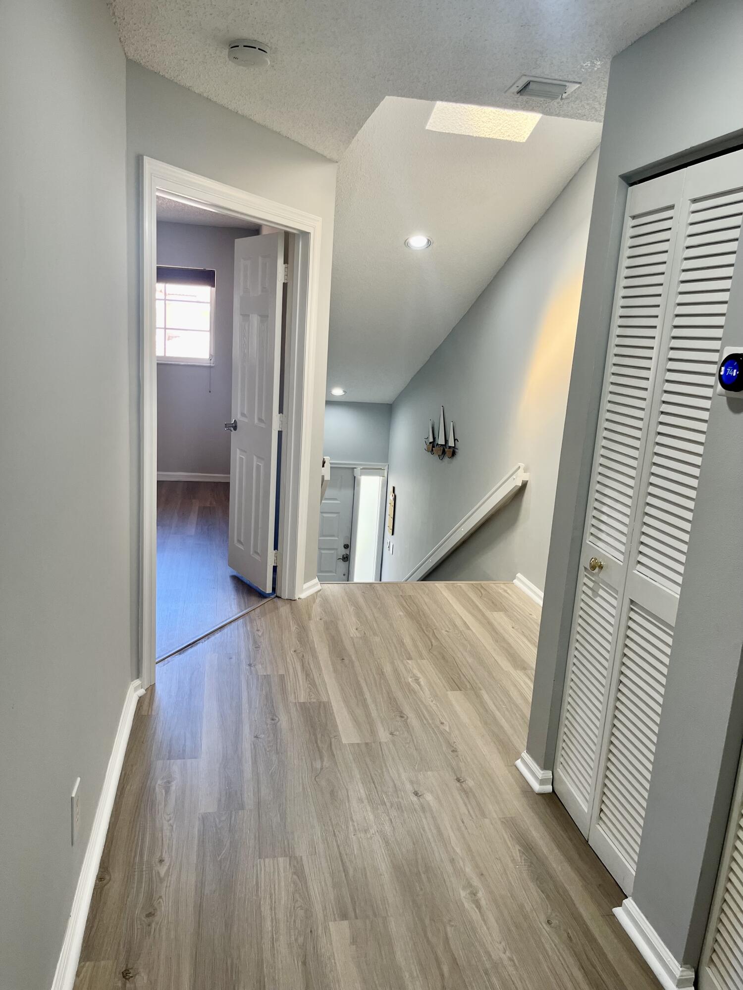 17262 Boca Club Boulevard, Unit 2407 Boca Raton, FL 33487 - Photo 8 of 25 a view of a hallway view and wooden floor and staircase