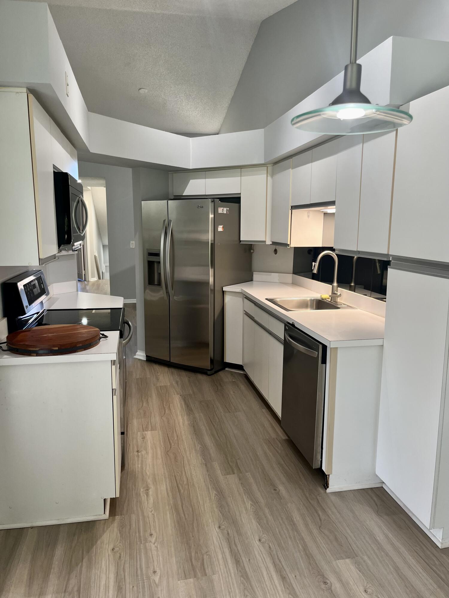 17262 Boca Club Boulevard, Unit 2407 Boca Raton, FL 33487 - Photo 9 of 25 a kitchen with a sink stove and refrigerator