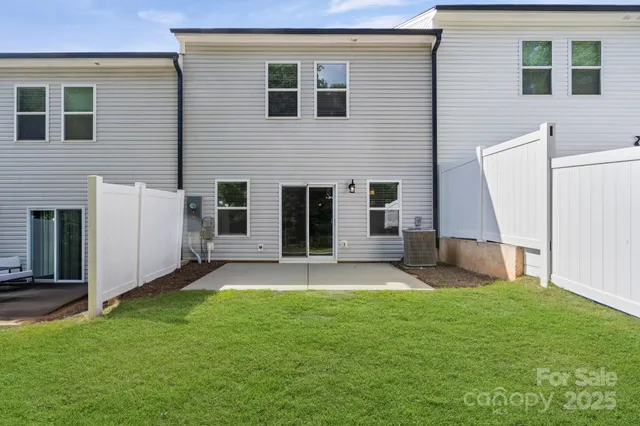 a view of a backyard with a garden and a tree