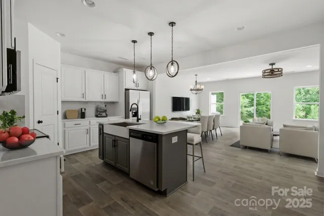 a kitchen with a stove a window and chairs