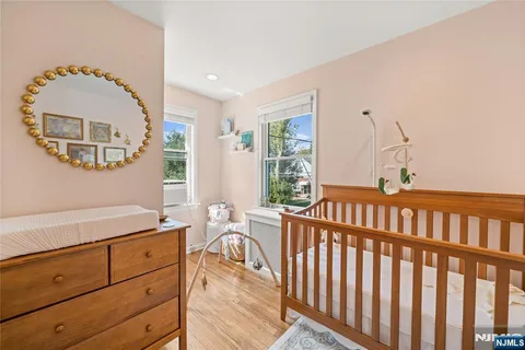 a view of a hallway to a livingroom with furniture