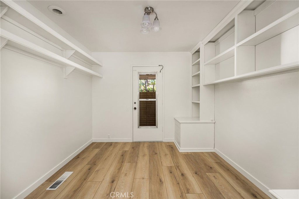 12011 Theta Road North Tustin, CA 92705 - Photo 46 of 49 A fifth room (10 x 10 - photo does not reflect size) offers built in drawers and shelvng, new Lux vinyl wood plank floors and a its own private entrance.