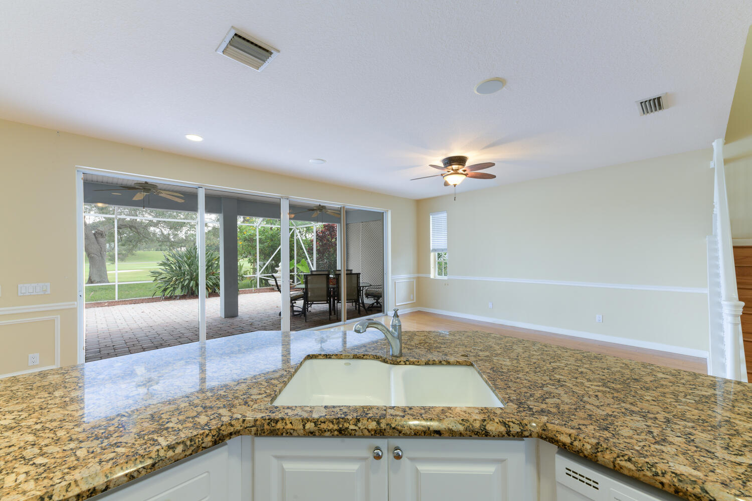 244 Barbados Drive Jupiter, FL 33458 - Photo 16 of 51 a view of a kitchen with granite countertop living room and floor to ceiling window